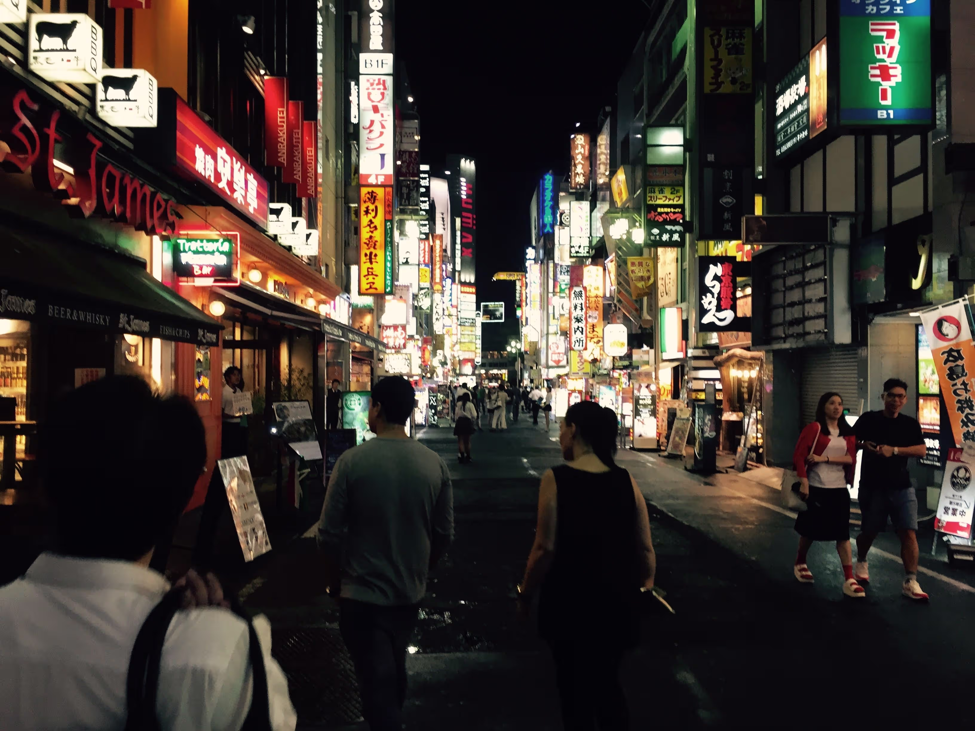 A crowd in Tokyo, Japan at night.